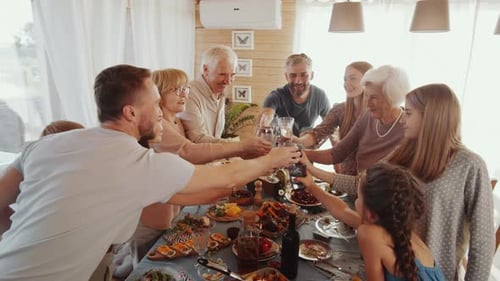 Family Cheers Together at a Holiday Meal