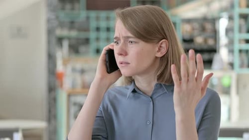Worried Woman Talking on Cell Phone