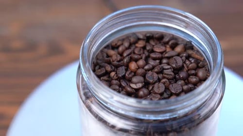 Fragrant Coffee Beans in Glass Jar Close Up
