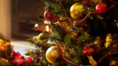 Christmas Tree Ornaments Glowing by Fireplace