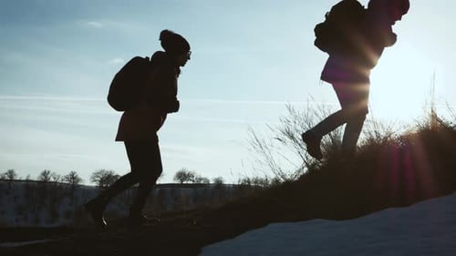 Happy Couple Man and Woman Tourist at Top of Mountain at Sunset Outdoors During a Hike