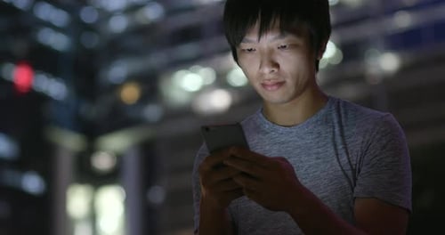 Man use of mobile phone in city