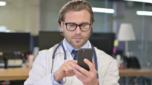 Doctor Using Smartphone in Modern Office Setting