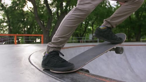 Skateboarder Doing a Tricks in a Concrete Skate Park