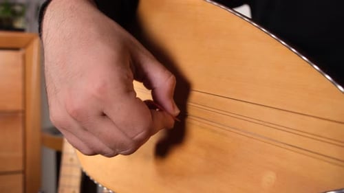 Man Plays Stringed Saz Instrument Close Up