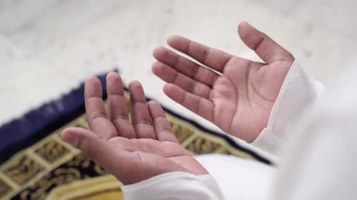 Person Praying with Hands Lifted in Peaceful Devotion