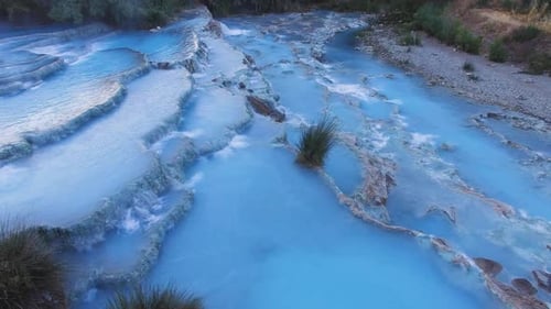Blue Water Stream Flows Through Rocky Terraces