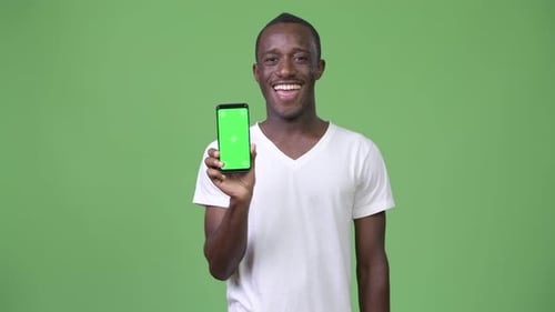 Young Adult Holding Smartphone with Green Screen