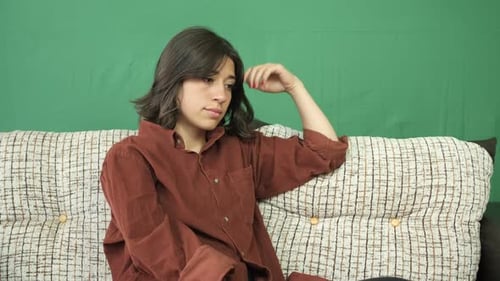 Woman Sitting On Sofa