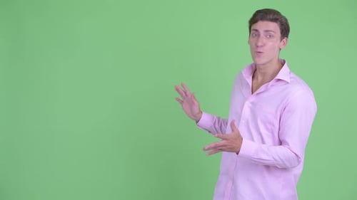 Young Adult Man Presenting to the Side