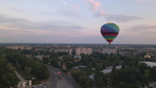 Colorful Hot Air Balloons Flying Over Green Park in Small European City at Summer Sunrise, Aerial