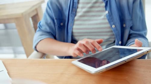 Woman Using Tablet at Desk Indoors