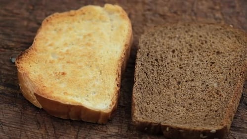 Toasted White and Brown Bread on Wood Surface