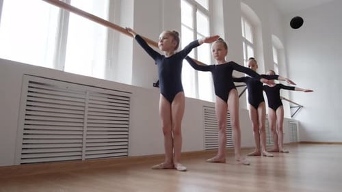 Little Ballerinas Practicing in Ballet School