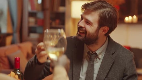 Man Toasting Wine With Friends at Dinner