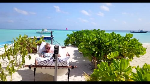 Man and woman relax on perfect sea view beach holiday by blue lagoon with white sandy background of