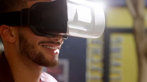 Man Smiles Wearing Virtual Reality Goggles, Close Up