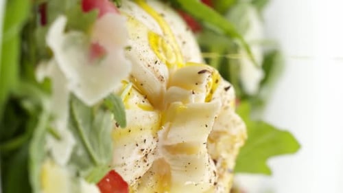 Vertical video: Mozzarella with salad in a plate