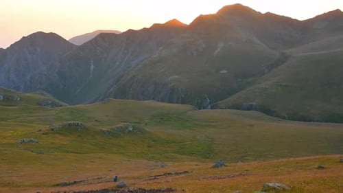 Hiker on Mountain Trail at Sunrise