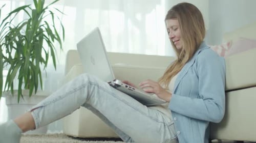 Woman Working on Laptop at Home
