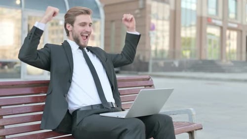 Successful Businessman Working on Laptop Outdoors