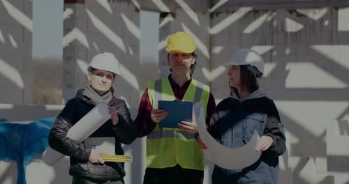 Construction Team at Building Site on Sunny Day
