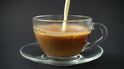 Milk Being Poured into a Cup of Coffee