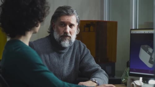 Engineers Designing Prototype at Computer Workstation