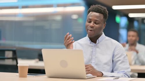 Man Engaged in Video Call at Desk