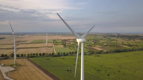 Aerial view of wind turbine generators in field producing clean ecological electricity.