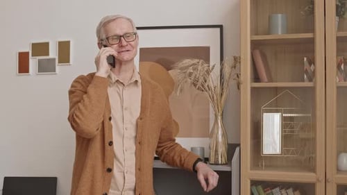 Senior Man Talking on a Phone Indoors