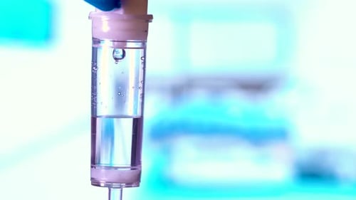 Dripping medical perfusion close up equipment in clinic background