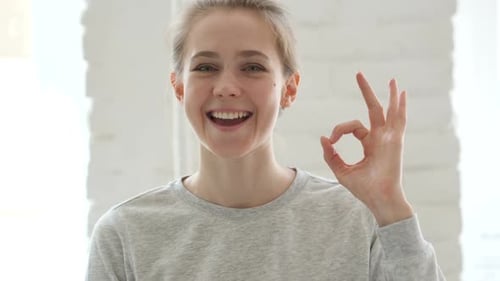 Young Adult Gives Okay Hand Gesture, Close Up