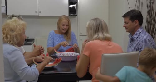 Family Gathering Enjoying Watermelon Together Indoors