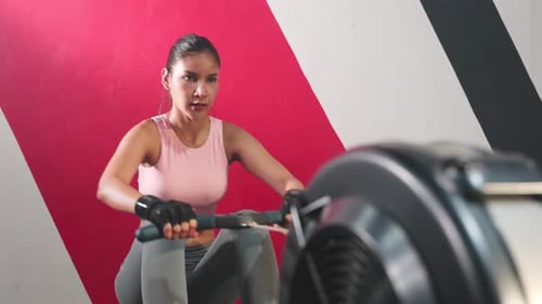 Asian attractive fitness trainer sport girl doing abs workout to maintain muscle in gym or stadium.