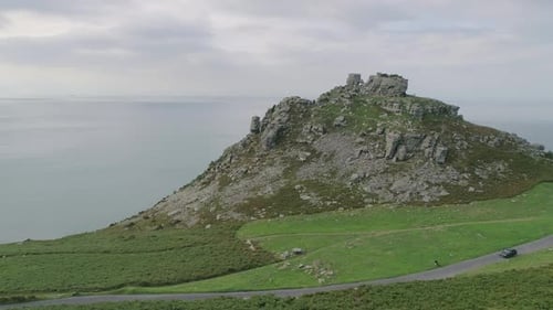 Aerial tracking forward closely past a rock stack towards the valley of rocks cliff face, inbetween