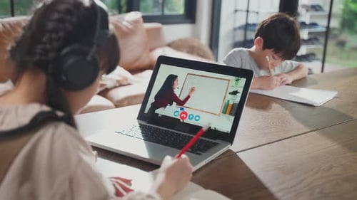 Homeschool Asian little young girl use laptop computer learning online class from school teacher.
