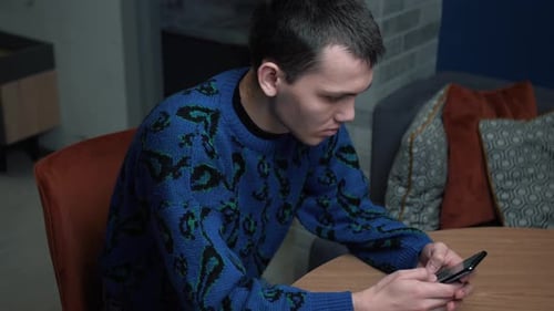 Young Adult Using Phone Indoors