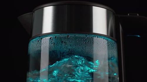 Water Boiling in Lit Glass Kettle