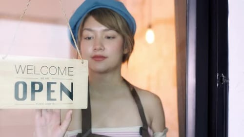 Woman Changes Open to Closed Sign