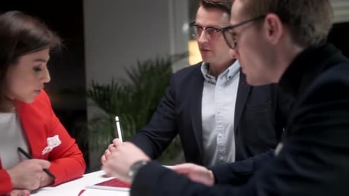 In Creative Office Productive Coworkers Standing at the Table, Company Meeting. Business People