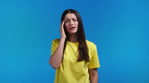 Portrait of Woman Having Headache Blue Studio Portrait
