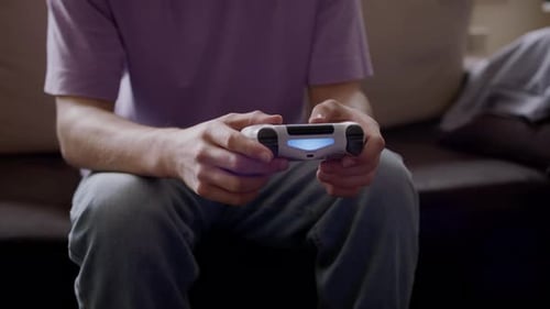 Hands play video games with a controller