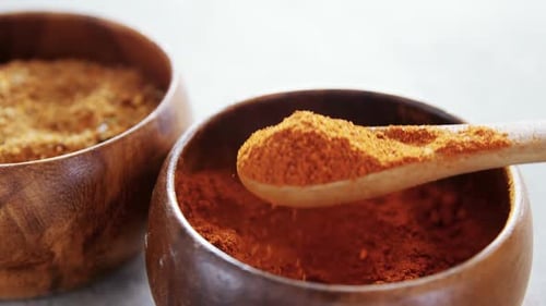 Cinnamon powder and red chili powder in bowl