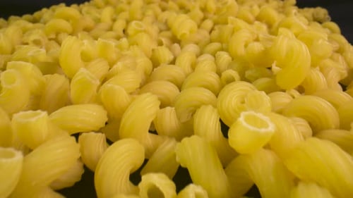 Close-up over a bunch of uncooked tortiglioni pasta.