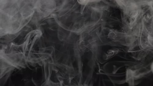 White Smoke Dancing Against Black Background
