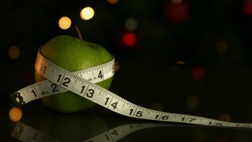 Green Apple with Measuring Tape on Black