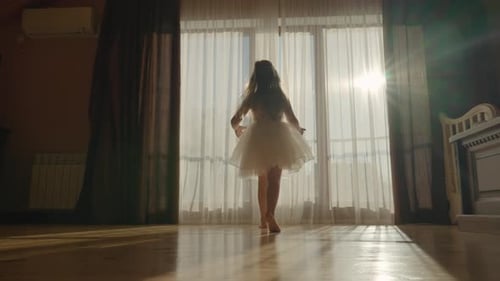 Girl Dancing in Sunlight With Flowing Curtains