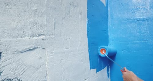 Close Up of Blue Paint Applied to White Wall with Roller Home Repairs