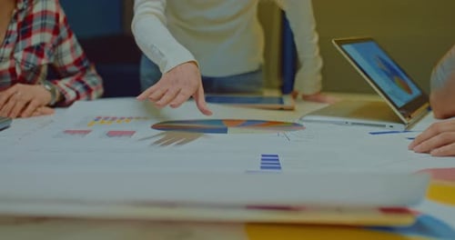 Business Team Discussing Charts and Graphs in Office